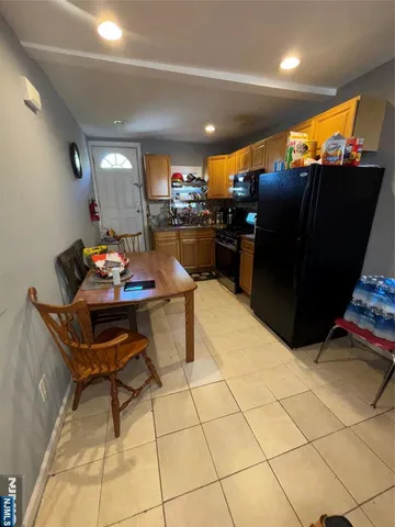 a bedroom with two beds and gym equipment