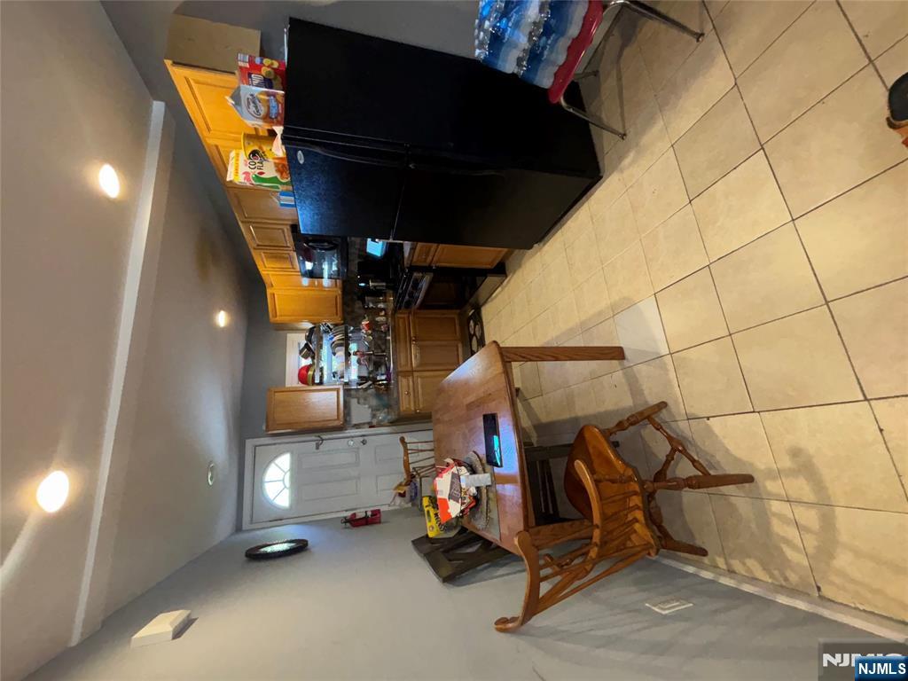 23 Oak Street Paterson, NJ 07501 - Photo 15 of 19 a living room with furniture and a flat screen tv