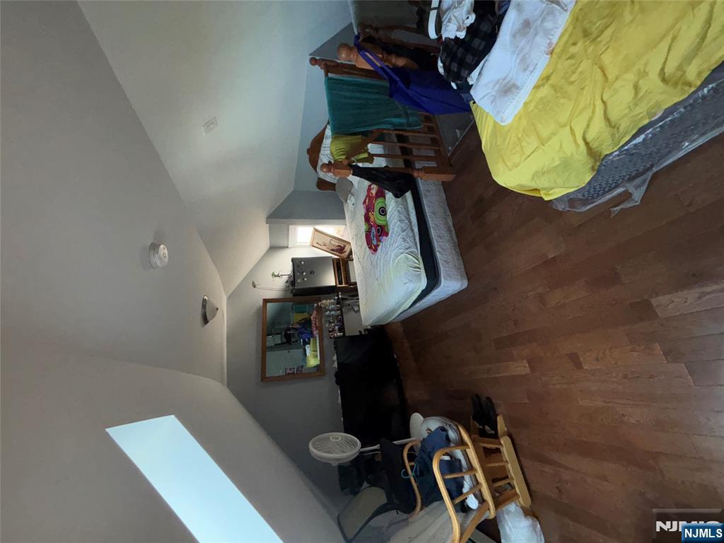 23 Oak Street Paterson, NJ 07501 - Photo 16 of 19 a bedroom with two beds and gym equipment