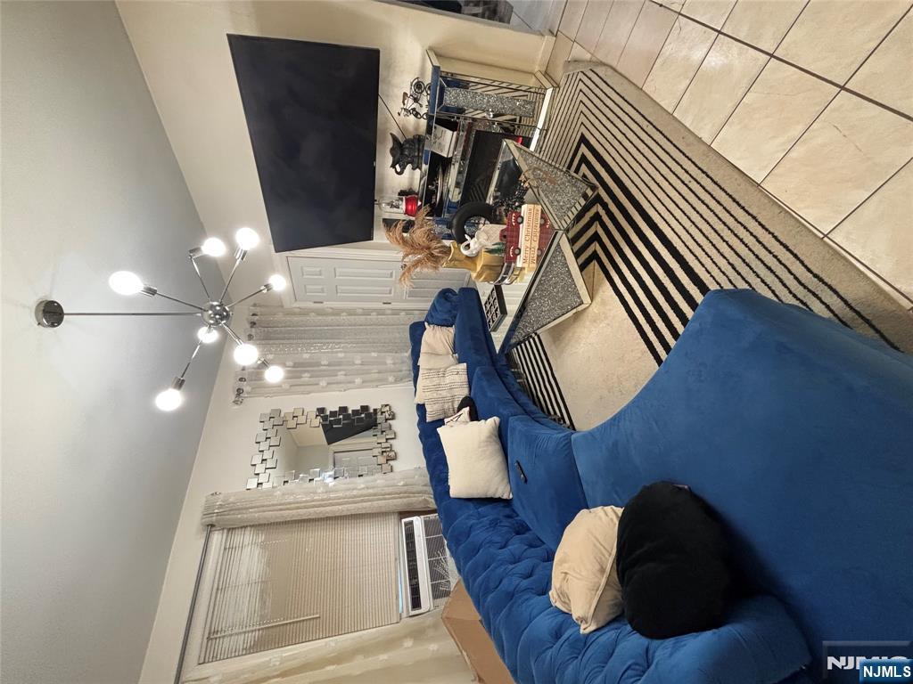 23 Oak Street Paterson, NJ 07501 - Photo 5 of 19 a living room with furniture and a flat screen tv