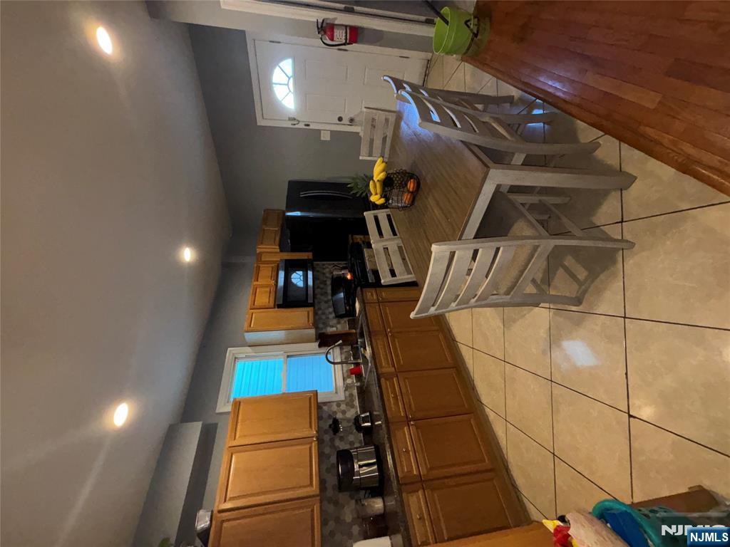23 Oak Street Paterson, NJ 07501 - Photo 9 of 19 a kitchen with a sink a counter top space cabinets and stainless steel appliances