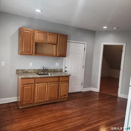 a spacious bathroom with a granite countertop sink and a mirror
