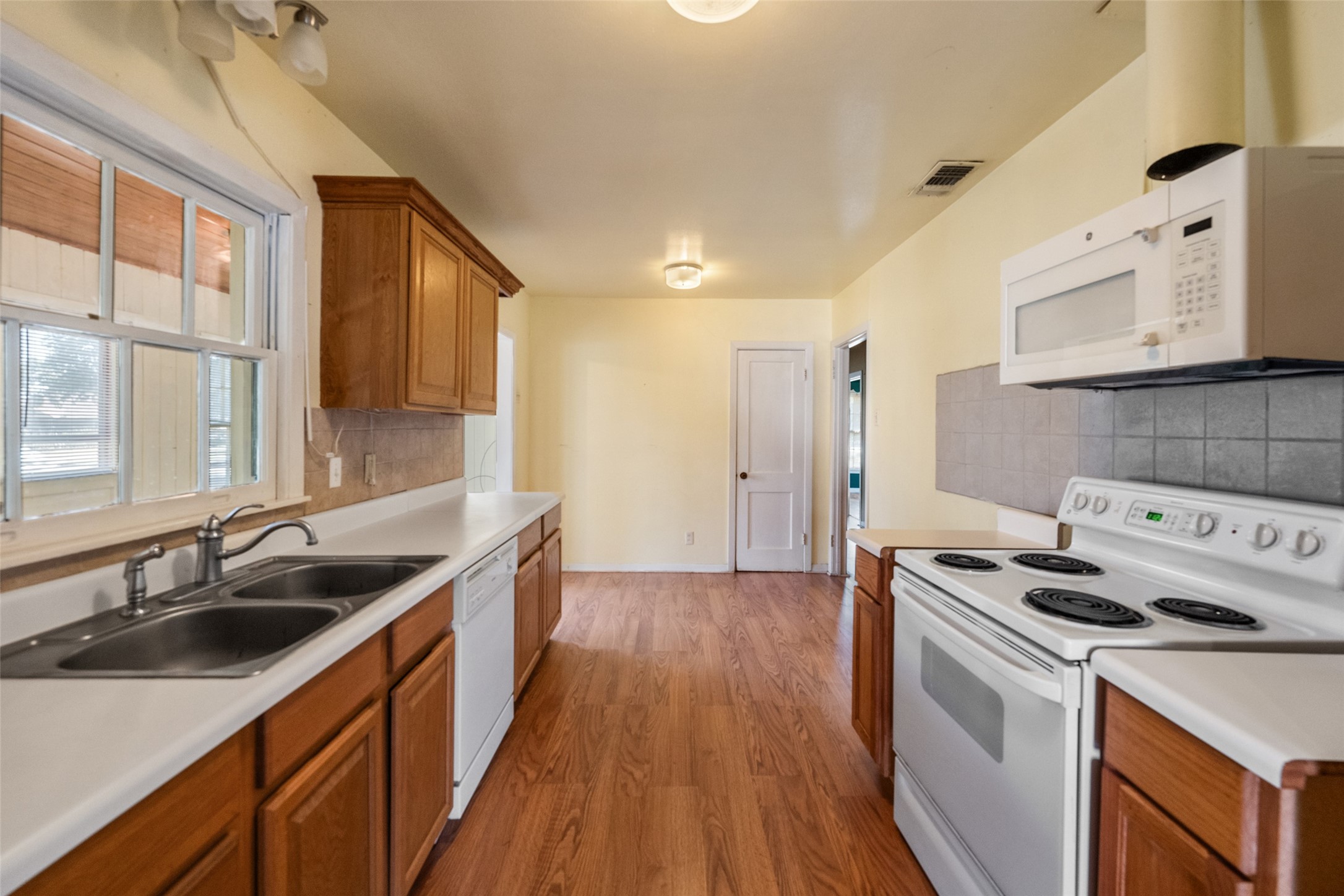 810 Main Street Hempstead, TX 77445 - Photo 12 of 32 Galley-style kitchen featuring abundant cabinetry, generous counter space, and a functional layout with adjoining dining area.