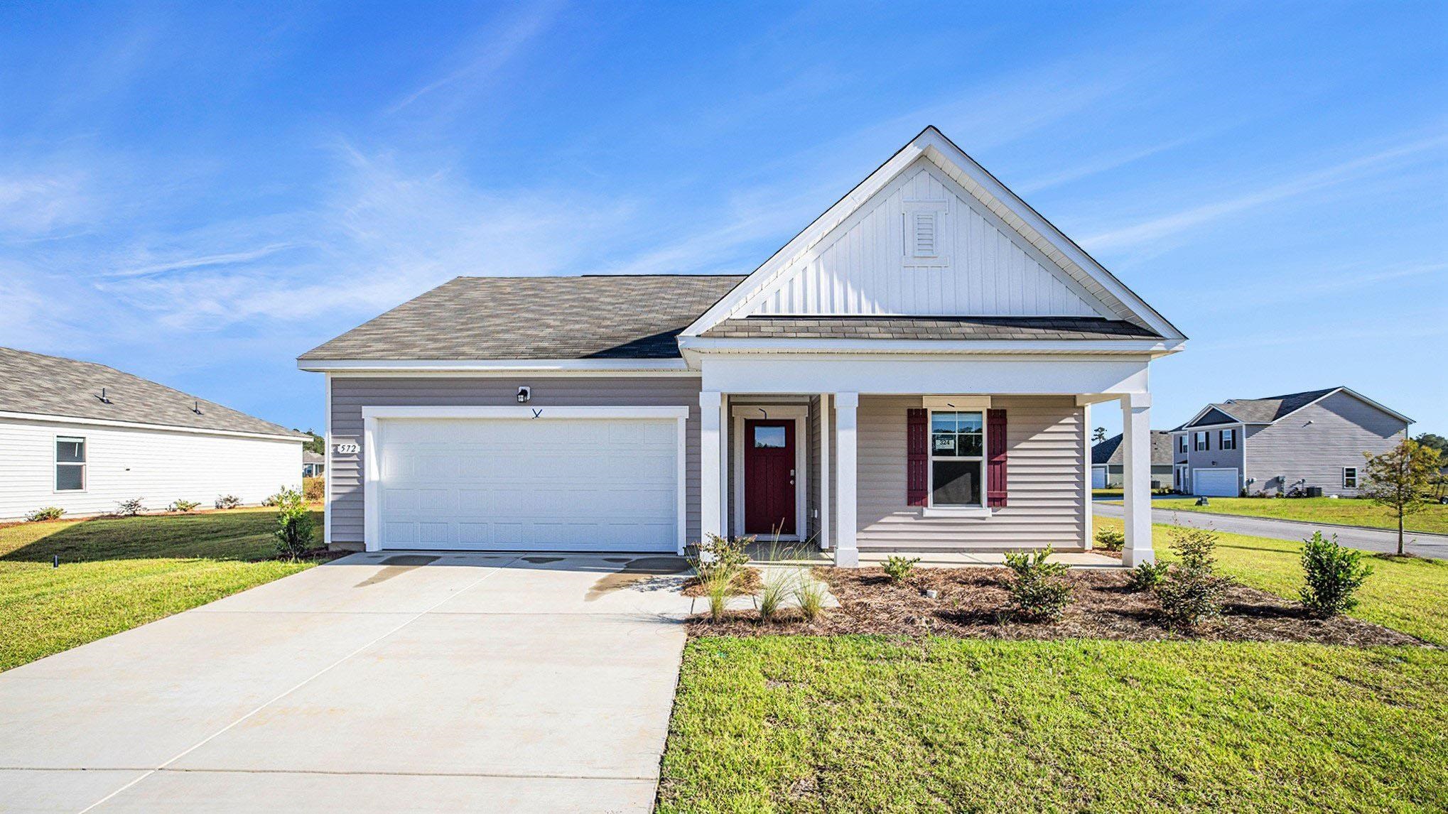 View of front of property featuring a porch, board and batten siding, driveway, and a front yard