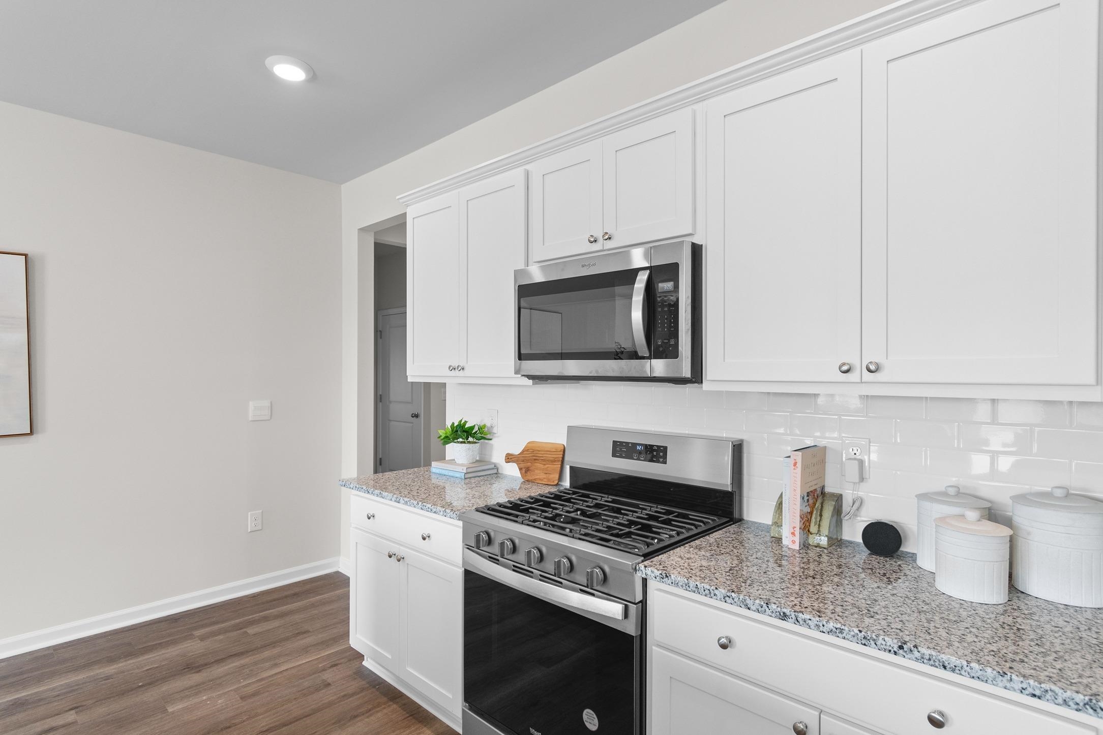 620 Anthem Court Conway, SC 29527 - Photo 7 of 25 Kitchen featuring stainless steel appliances, light stone counters, white cabinets, and recessed lighting