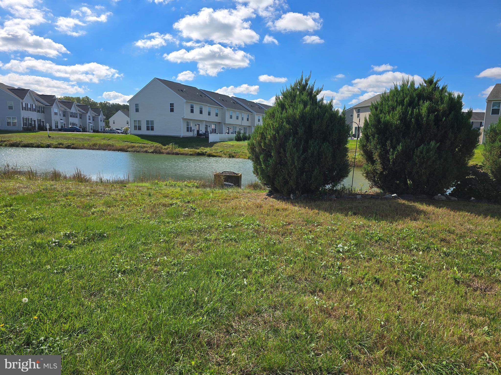 181 Bobbys Branch Road, Unit 35 Millsboro, DE 19966 - Photo 25 of 26 a view of a house with a yard and swimming pool
