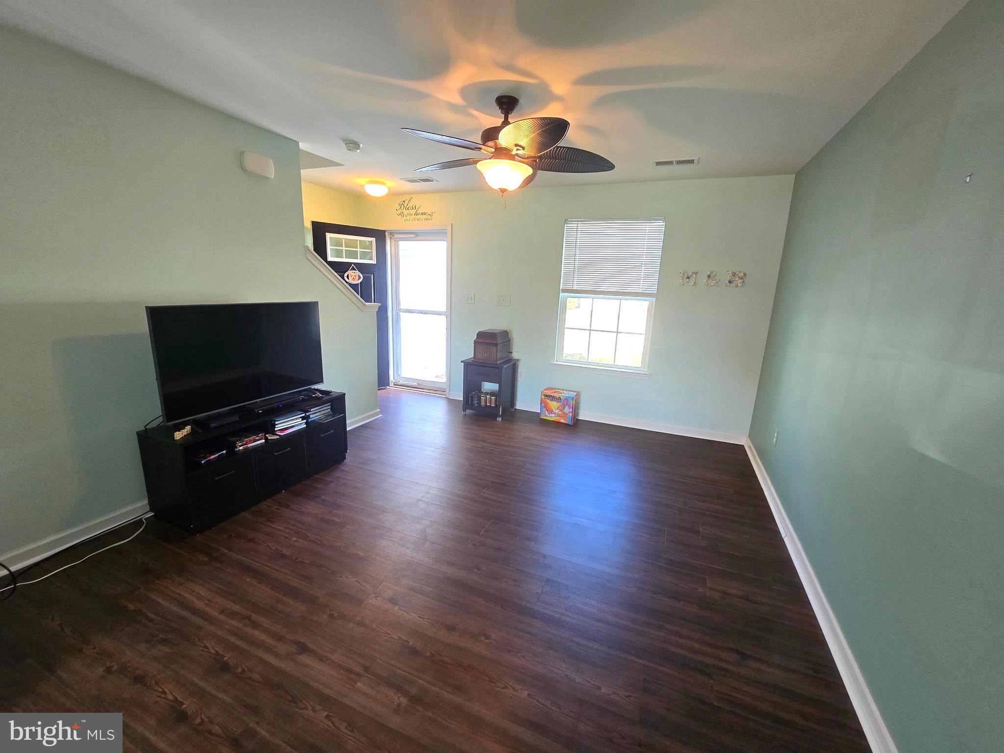 181 Bobbys Branch Road, Unit 35 Millsboro, DE 19966 - Photo 3 of 26 a living room with furniture and a flat screen tv