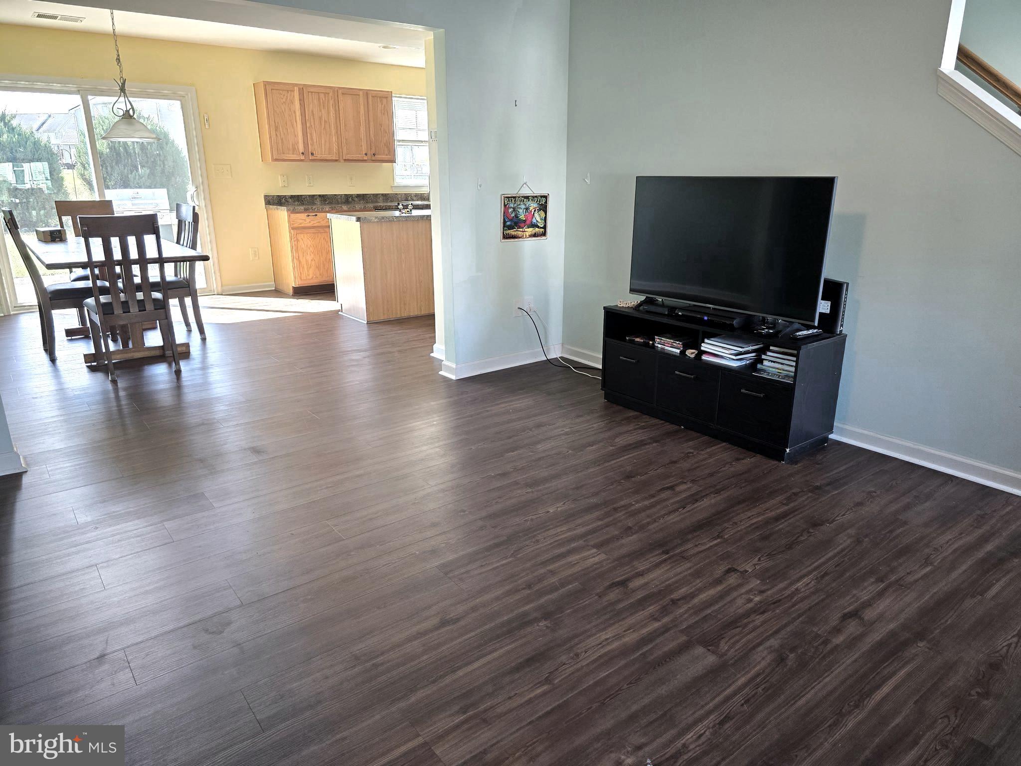 181 Bobbys Branch Road, Unit 35 Millsboro, DE 19966 - Photo 5 of 26 a living room with furniture and a flat screen tv