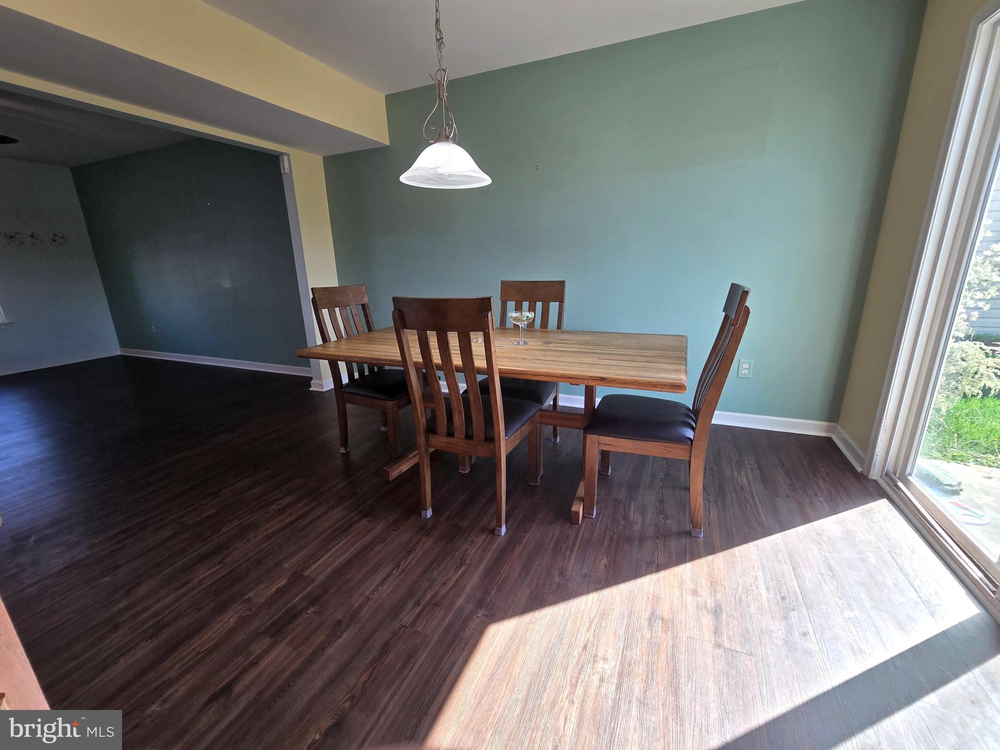 181 Bobbys Branch Road, Unit 35 Millsboro, DE 19966 - Photo 7 of 26 a dining room with furniture a chandelier and wooden floor