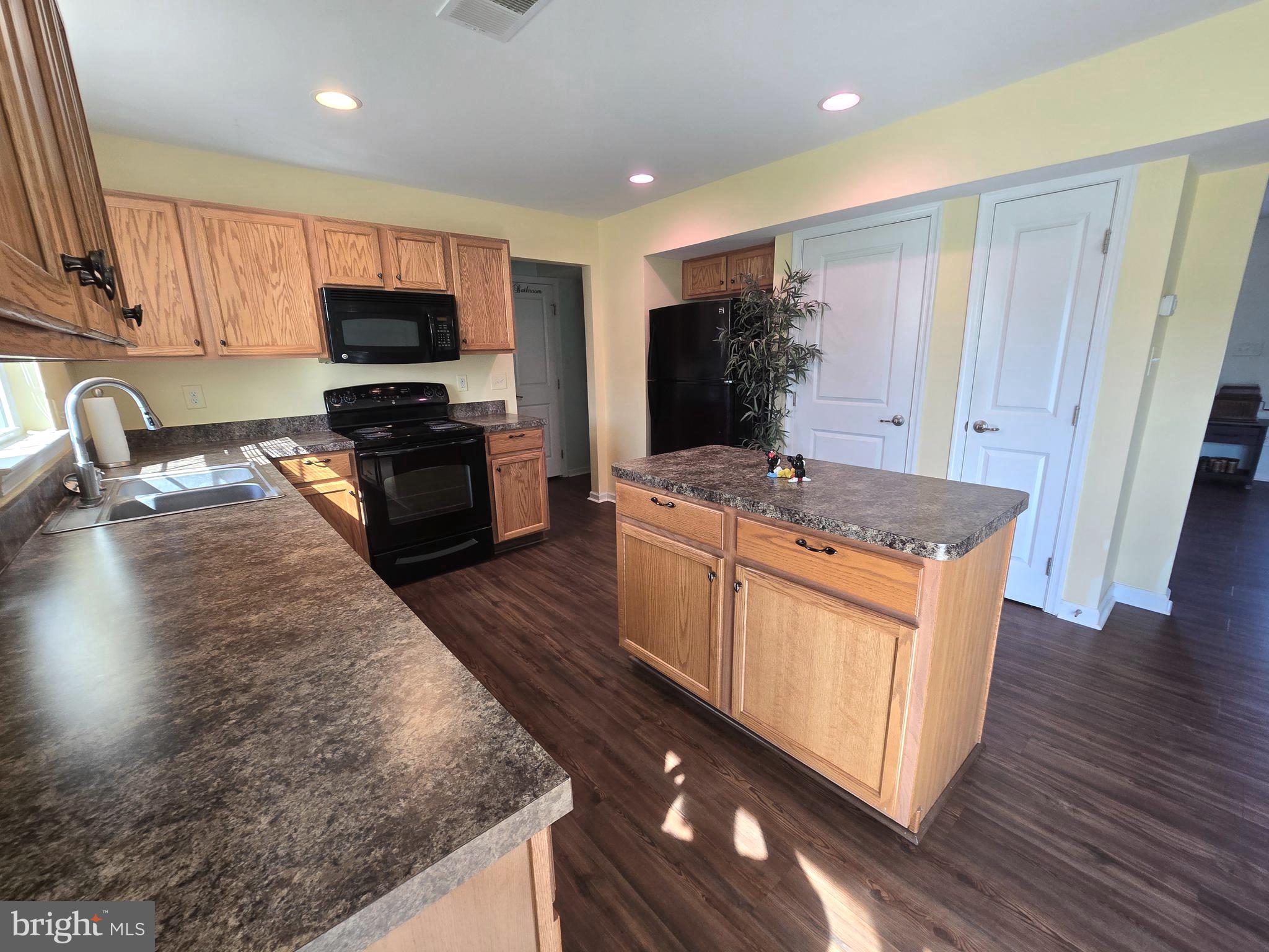 181 Bobbys Branch Road, Unit 35 Millsboro, DE 19966 - Photo 8 of 26 a kitchen with stainless steel appliances granite countertop a sink stove and refrigerator