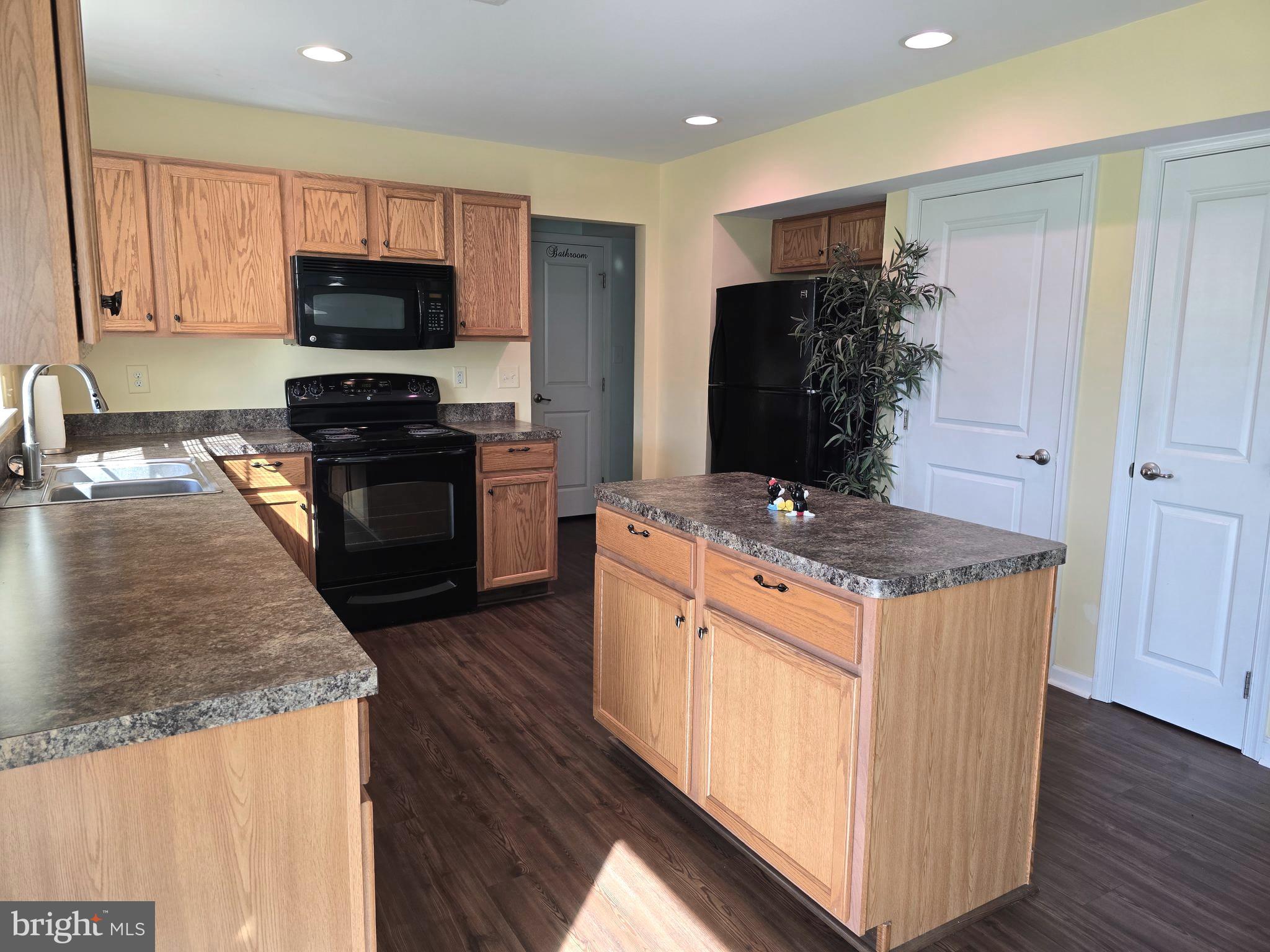 181 Bobbys Branch Road, Unit 35 Millsboro, DE 19966 - Photo 10 of 26 a kitchen with granite countertop a stove and a sink