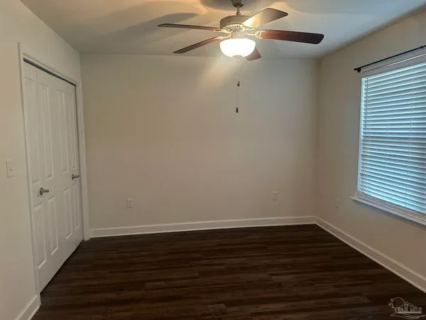 an empty room with wooden floor