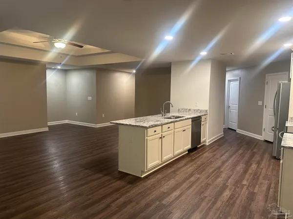 a kitchen with a stove top oven sink and refrigerator