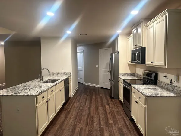 a room with a wooden floor and white walls