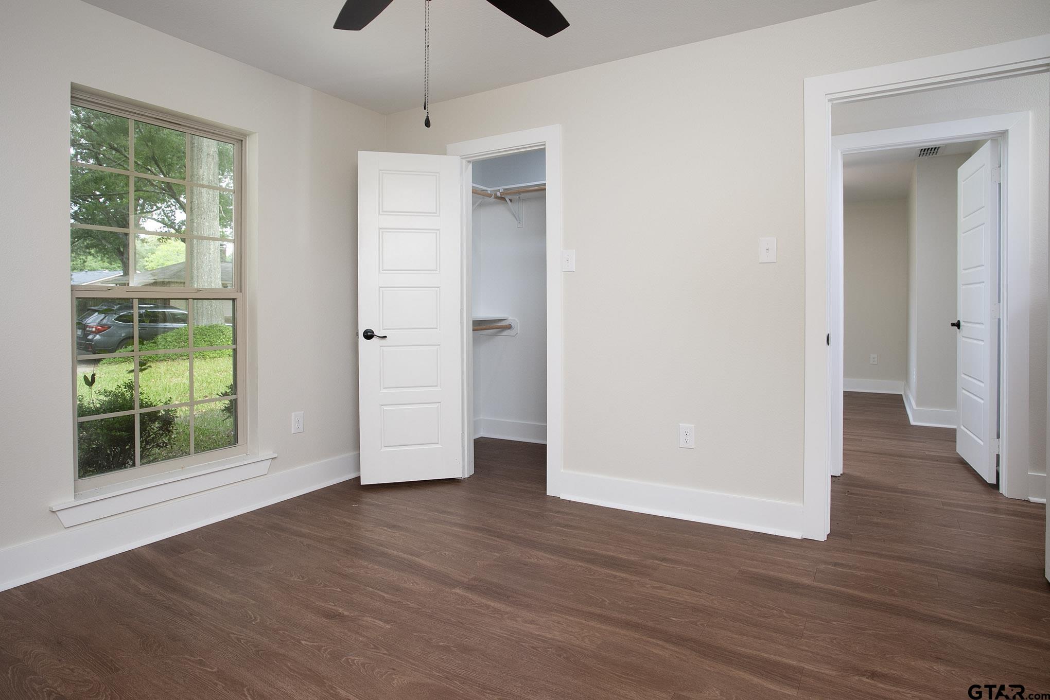 610 Rockwall Drive Longview, TX 75604 - Photo 13 of 39 a view of empty room with wooden floor and fan