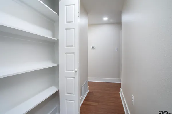 a view of a hallway with wooden floor