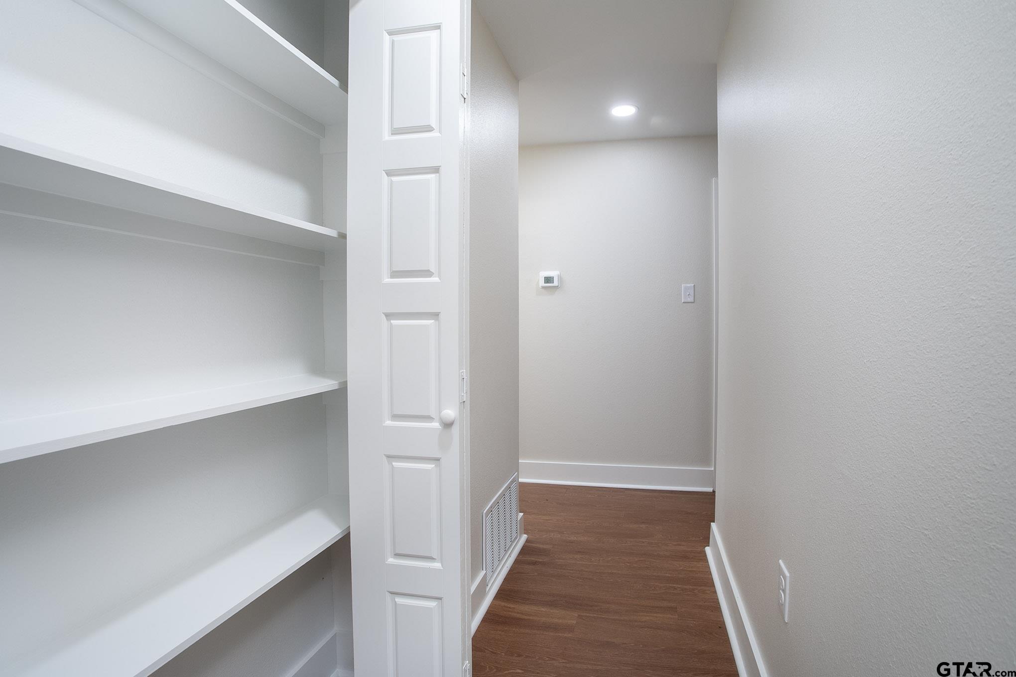 610 Rockwall Drive Longview, TX 75604 - Photo 16 of 39 a view of a hallway with wooden floor