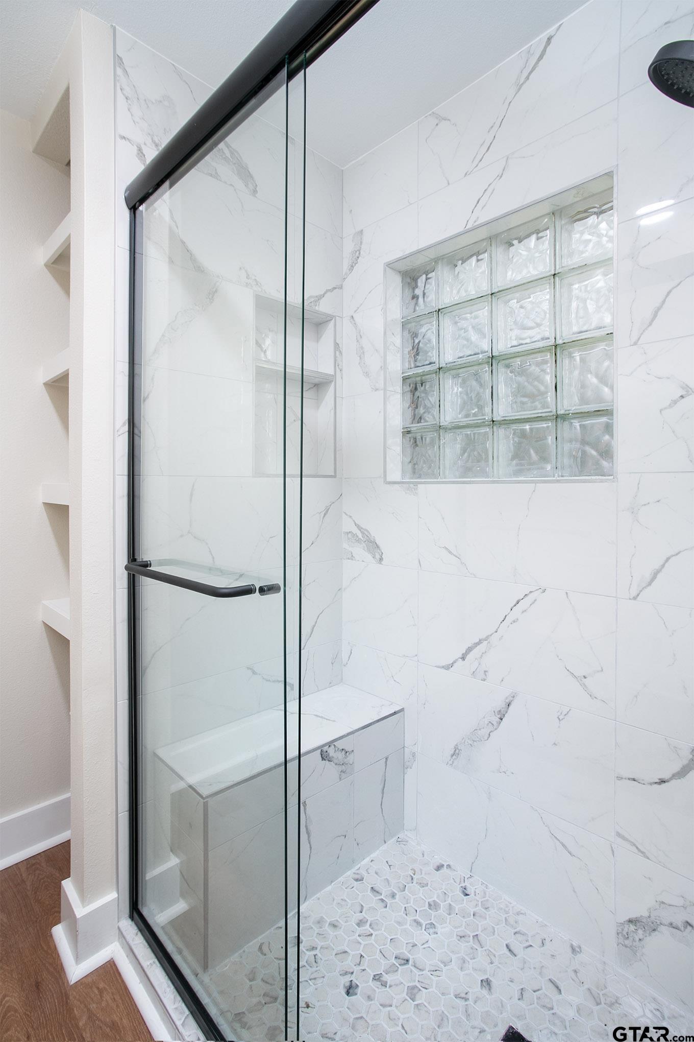 610 Rockwall Drive Longview, TX 75604 - Photo 25 of 39 a bathroom with a glass shower door and a window