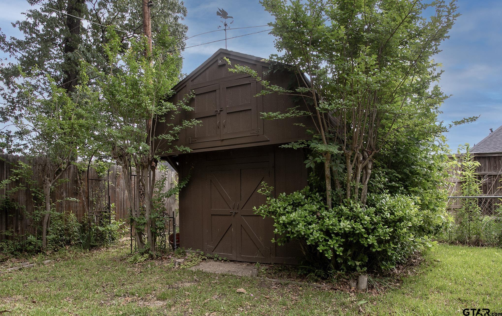 610 Rockwall Drive Longview, TX 75604 - Photo 29 of 39 a house with trees in front of it
