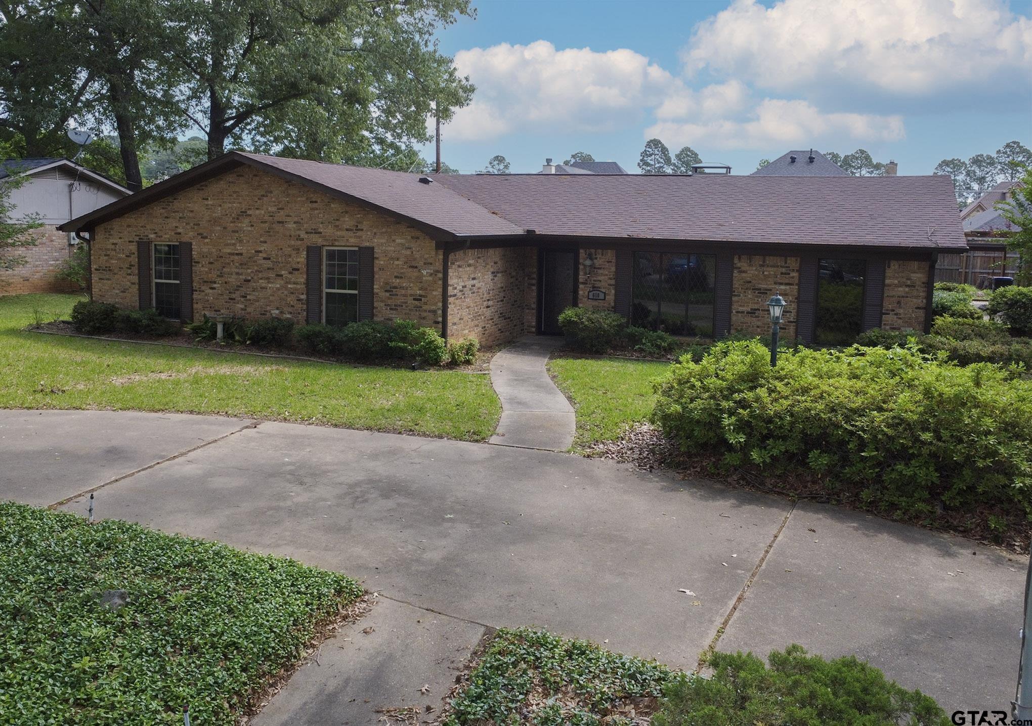 610 Rockwall Drive Longview, TX 75604 - Photo 31 of 39 a front view of a house with a yard and garage