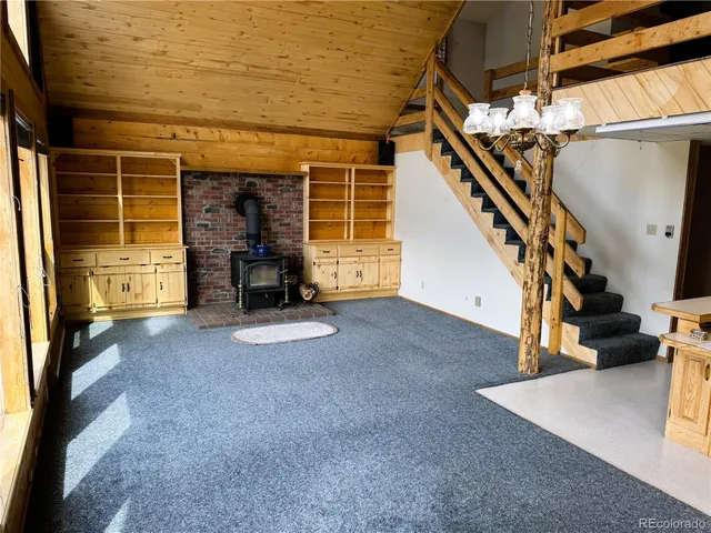 a view of a house with a barbeque and wooden stairs