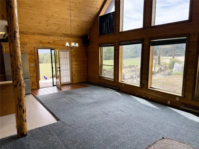 a view of an empty room with large windows
