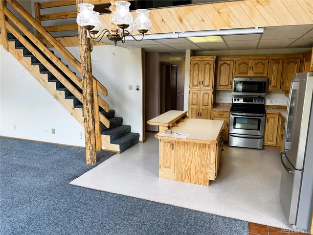 a kitchen with sink refrigerator and stove