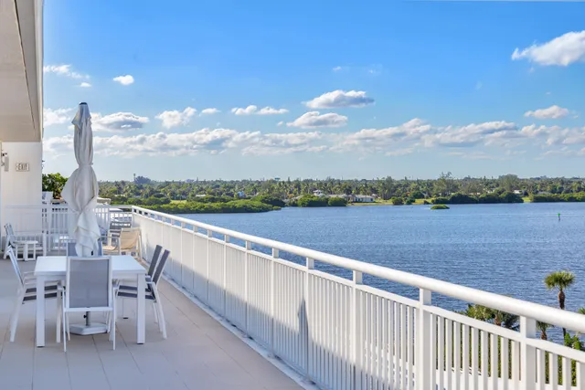 a view of swimming pool with outdoor seating and lake view