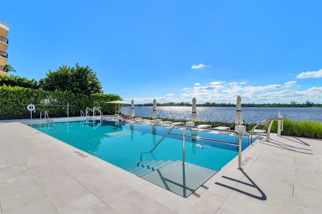 a view of a swimming pool and lounge chairs