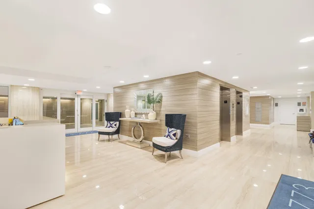 a living room with furniture and kitchen view