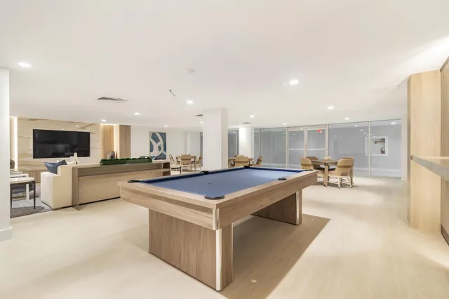 a large kitchen with a table and chairs in it