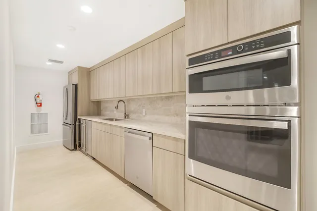 a kitchen with granite countertop white cabinets and white stainless steel appliances