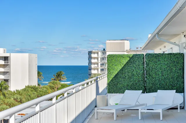 a view of an chairs and table in patio
