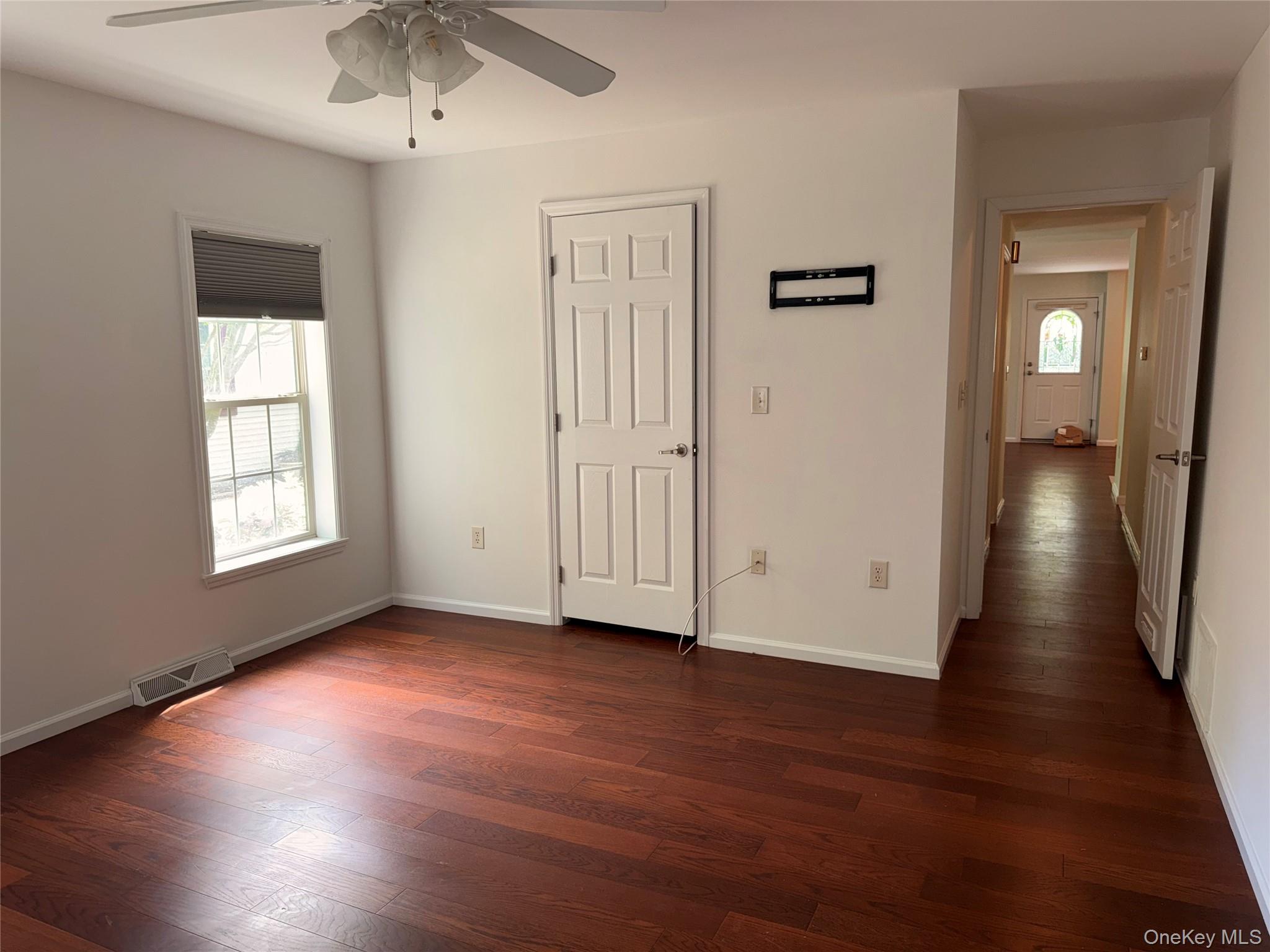 1661 Old Country Road, Unit 516 Riverhead, NY 11901 - Photo 34 of 50 an empty room with wooden floor and a window
