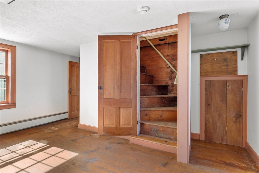 5 Carpenter Hill Road Charlton, MA 01507 - Photo 17 of 42 a view of an empty room with wooden floor and windows
