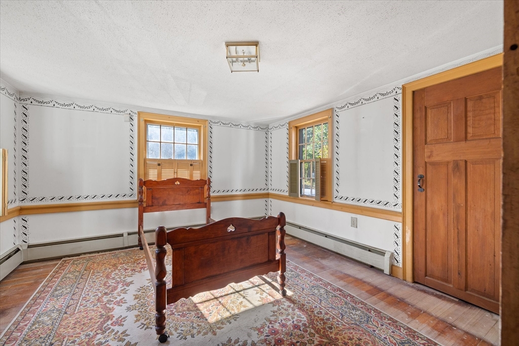 5 Carpenter Hill Road Charlton, MA 01507 - Photo 20 of 42 a spacious bedroom with a bed and a window