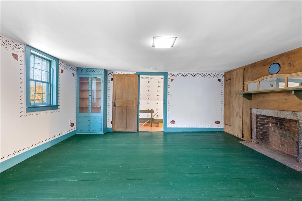 5 Carpenter Hill Road Charlton, MA 01507 - Photo 28 of 42 a view of an empty room with window and fireplace
