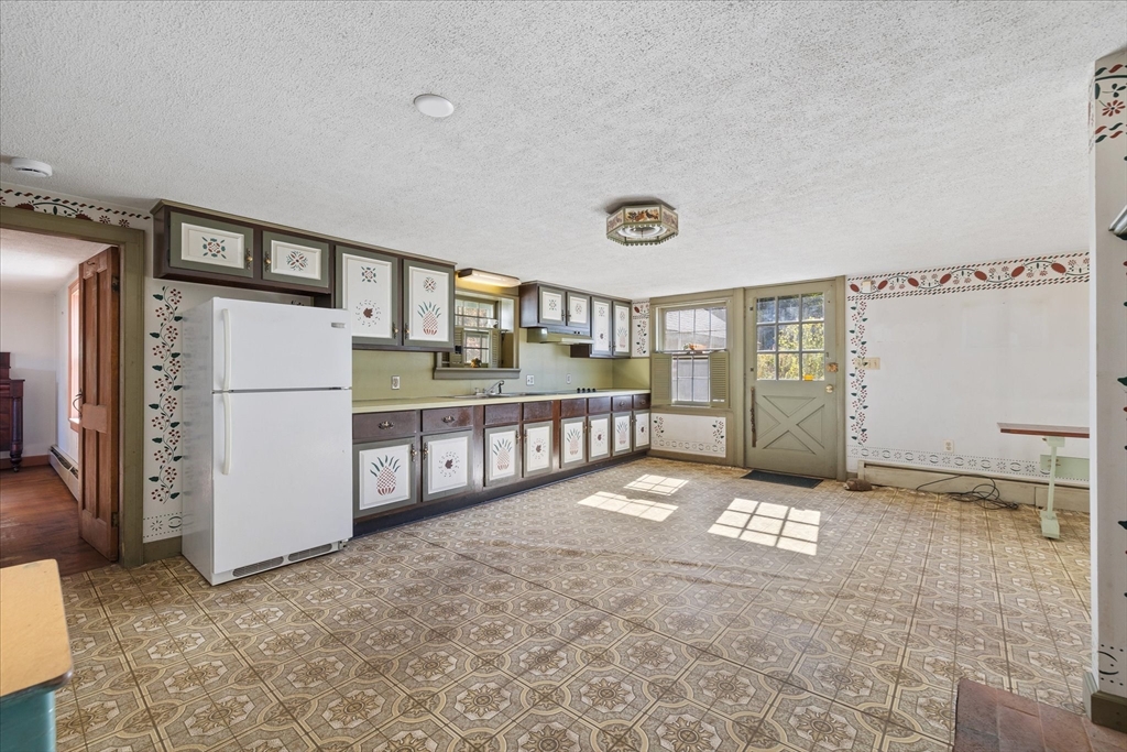 5 Carpenter Hill Road Charlton, MA 01507 - Photo 10 of 42 a view of an empty room and kitchen