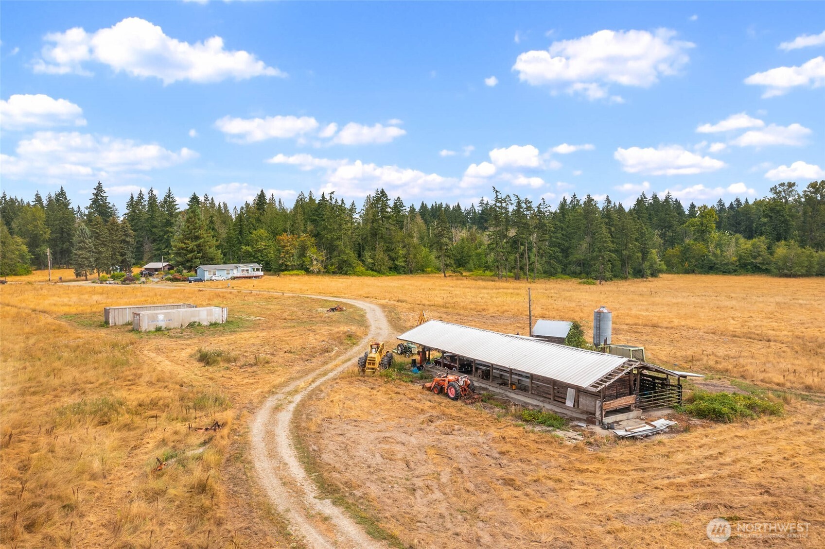 1716 304th Street East Roy, WA 98580 - Photo 16 of 21 a view of a lake with houses in the back