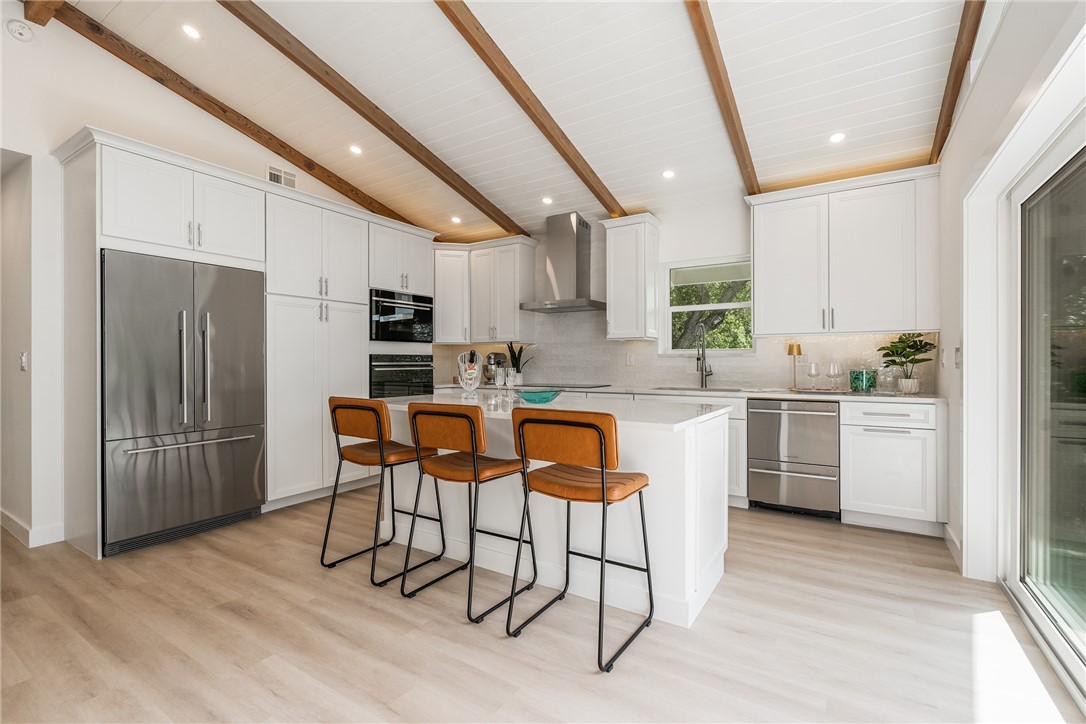 1881 Pebble Path Vero Beach, FL 32963 - Photo 14 of 34 a kitchen with white cabinets and stainless steel appliances