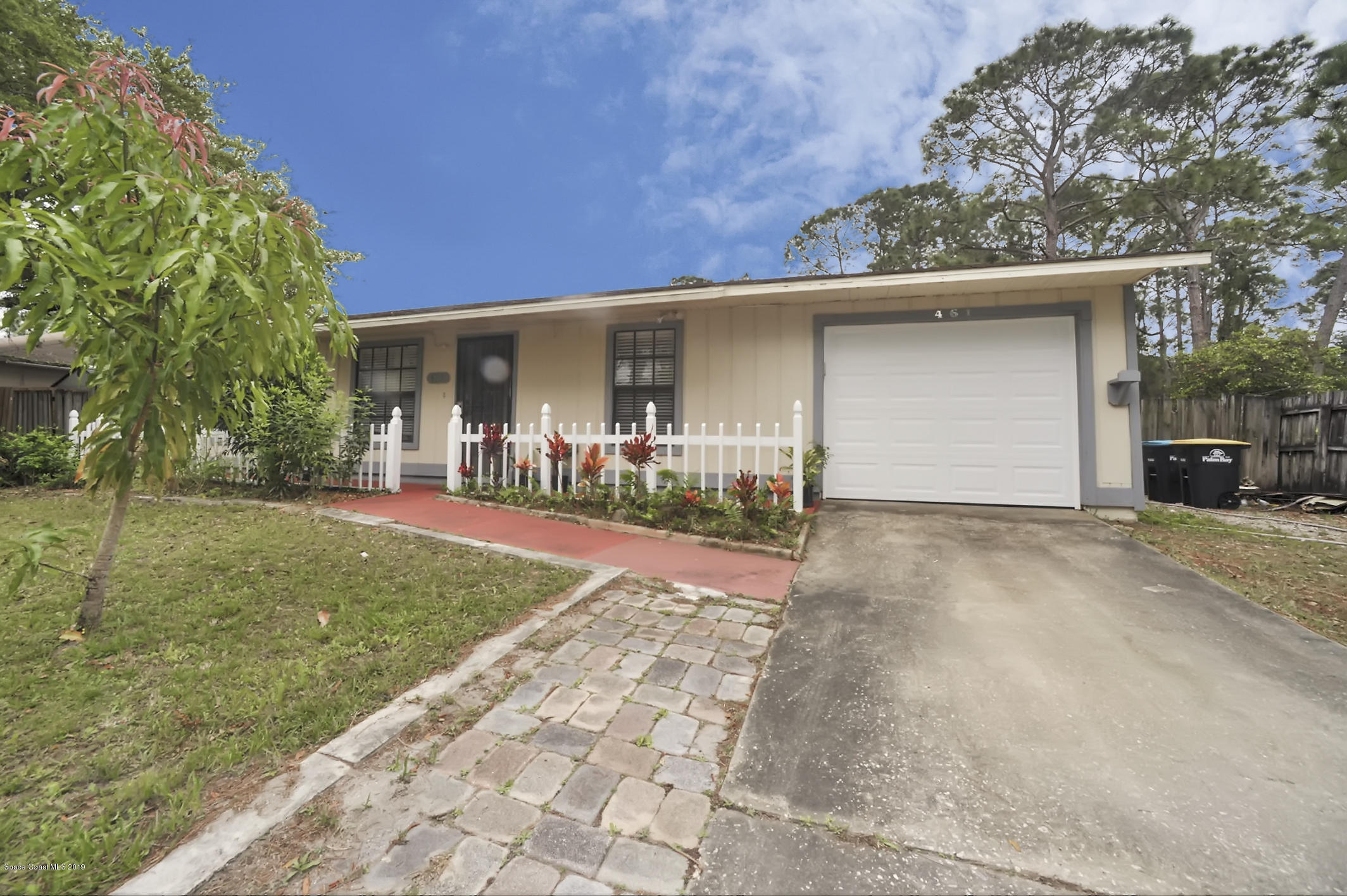461 Wildmer Road Southwest Palm Bay, FL 32908 - Photo 2 of 15 a front view of a house with a yard and garage