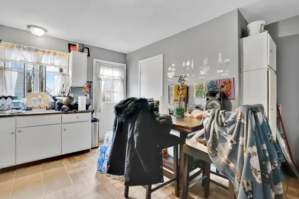 a very nice looking dining room with a large window and chairs