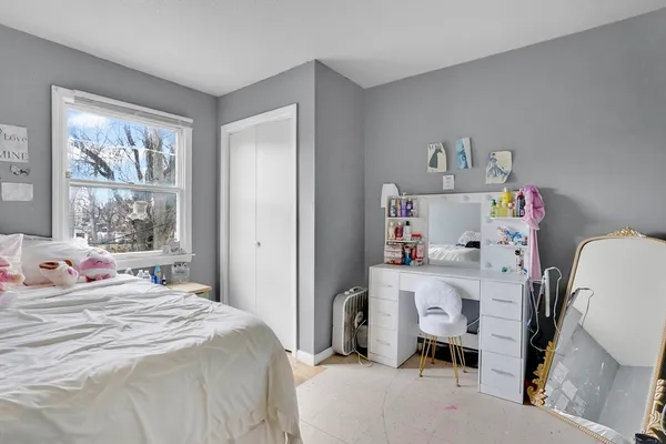 a bedroom with a bed and a window