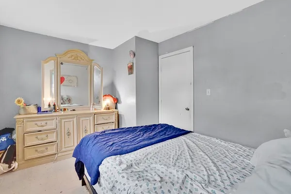 a bedroom with a bed and a dresser