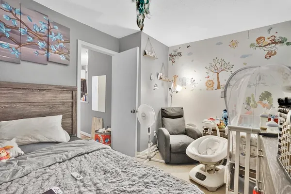 a bedroom with a bed and a couch