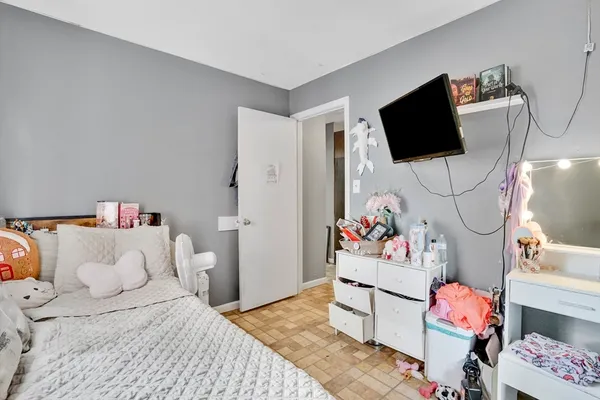a bedroom with a bed and flat screen tv
