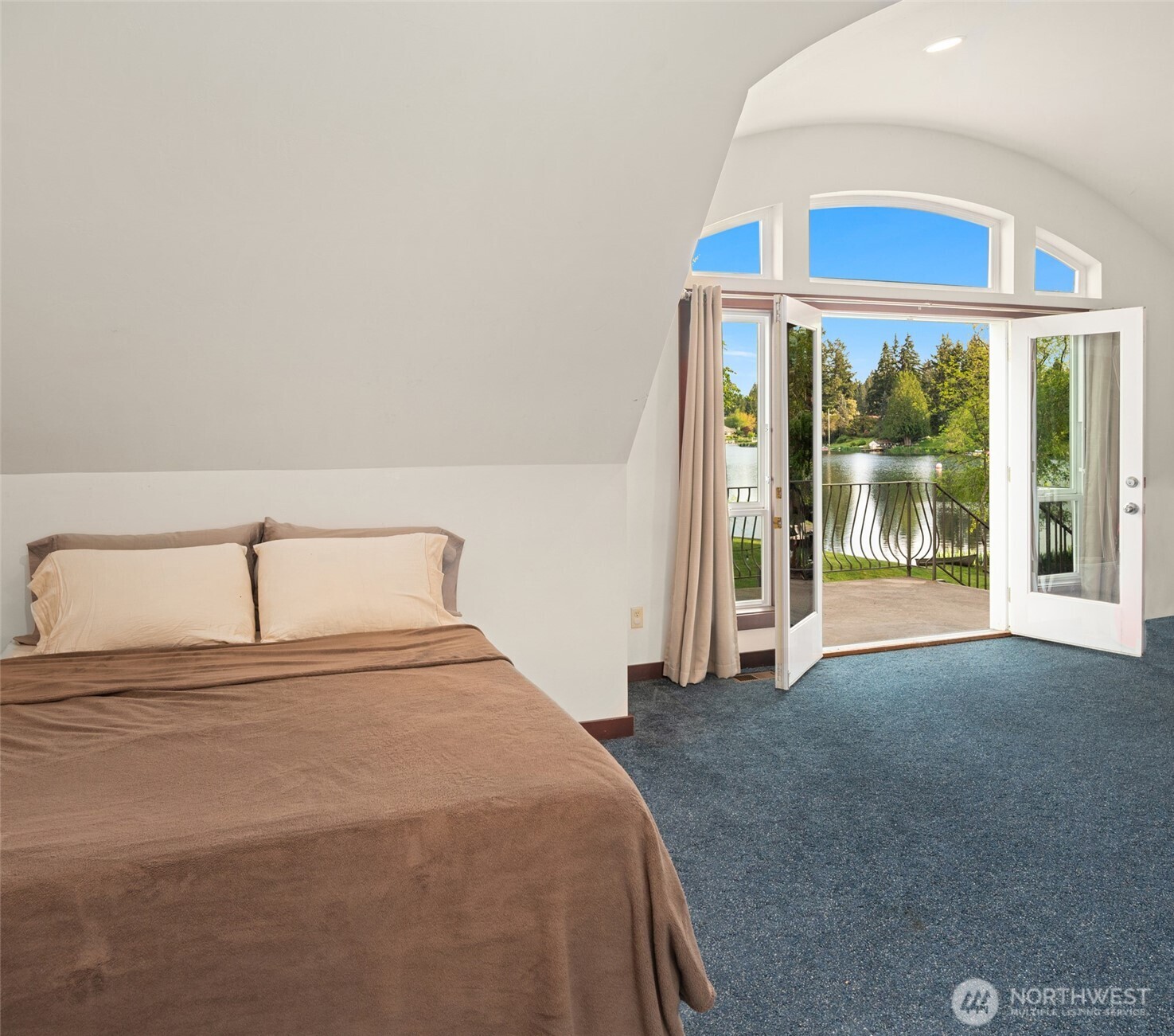 1000 Creso Road South Spanaway, WA 98387 - Photo 23 of 40 a bedroom with a large bed and a large window