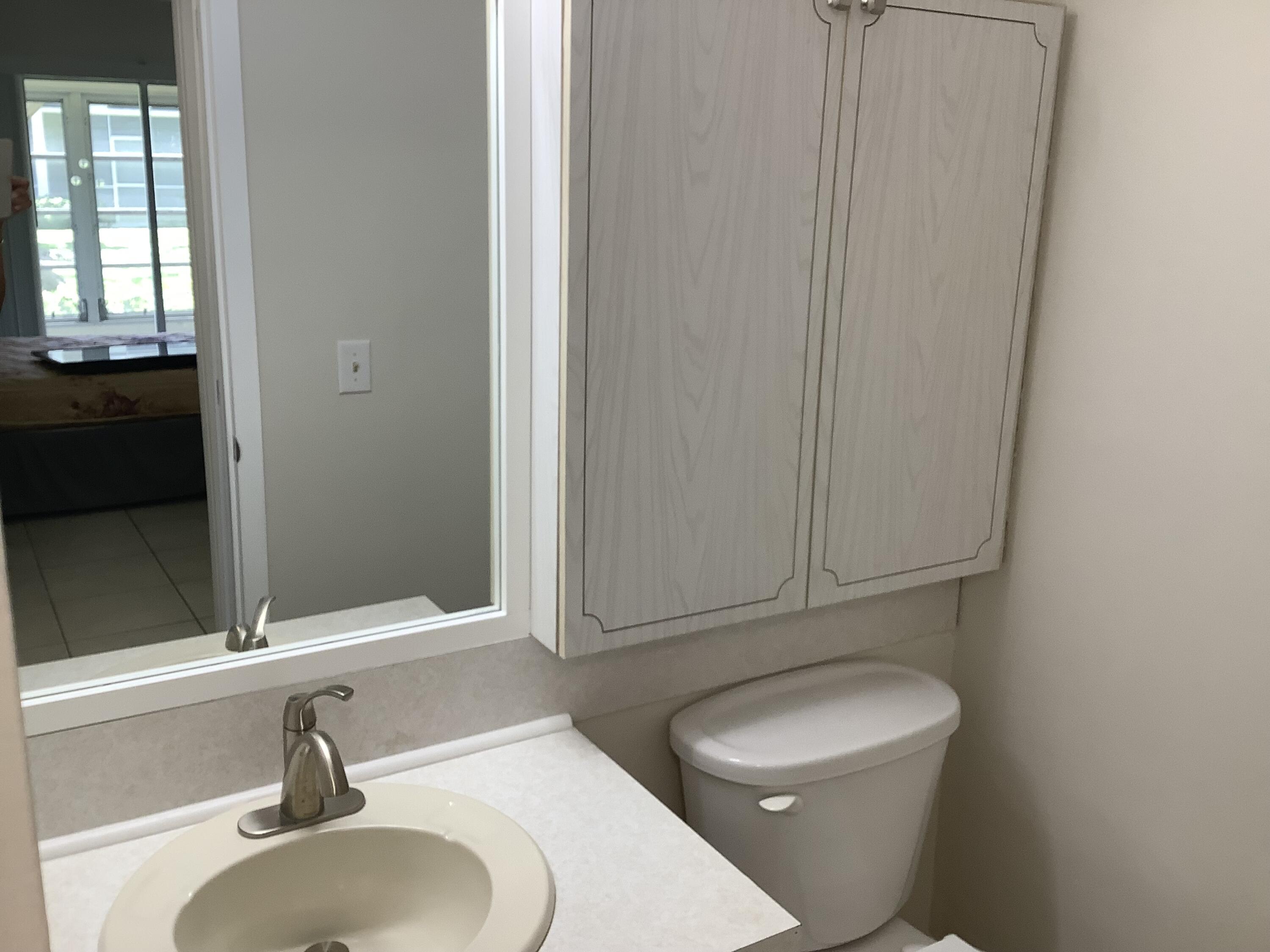 560 Fanshaw North, Unit 560 Boca Raton, FL 33434 - Photo 15 of 26 a bathroom with a sink a toilet and tub