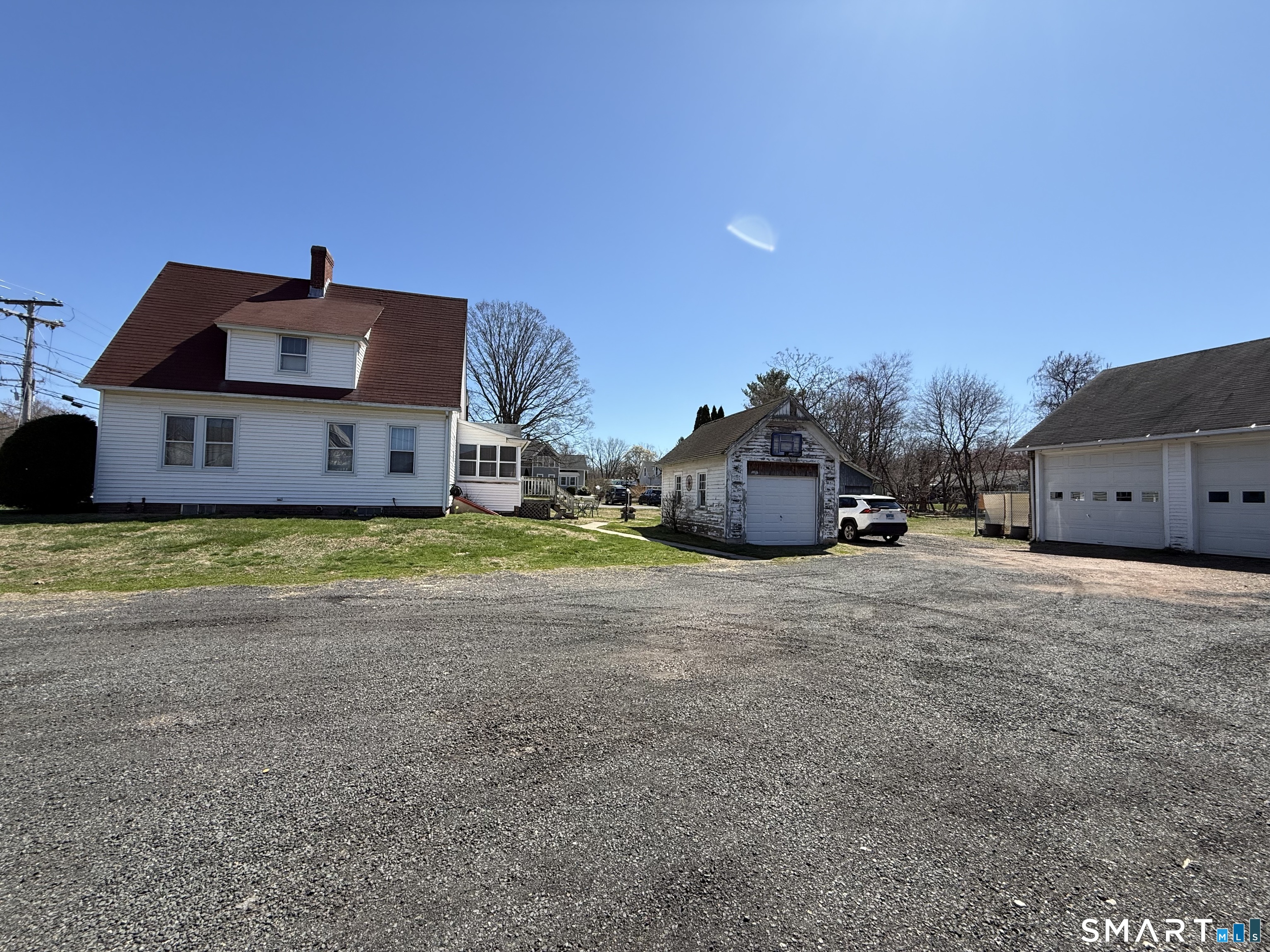 616 Main Street Somers, CT 06071 - Photo 6 of 24 a front view of a house with a yard and garage
