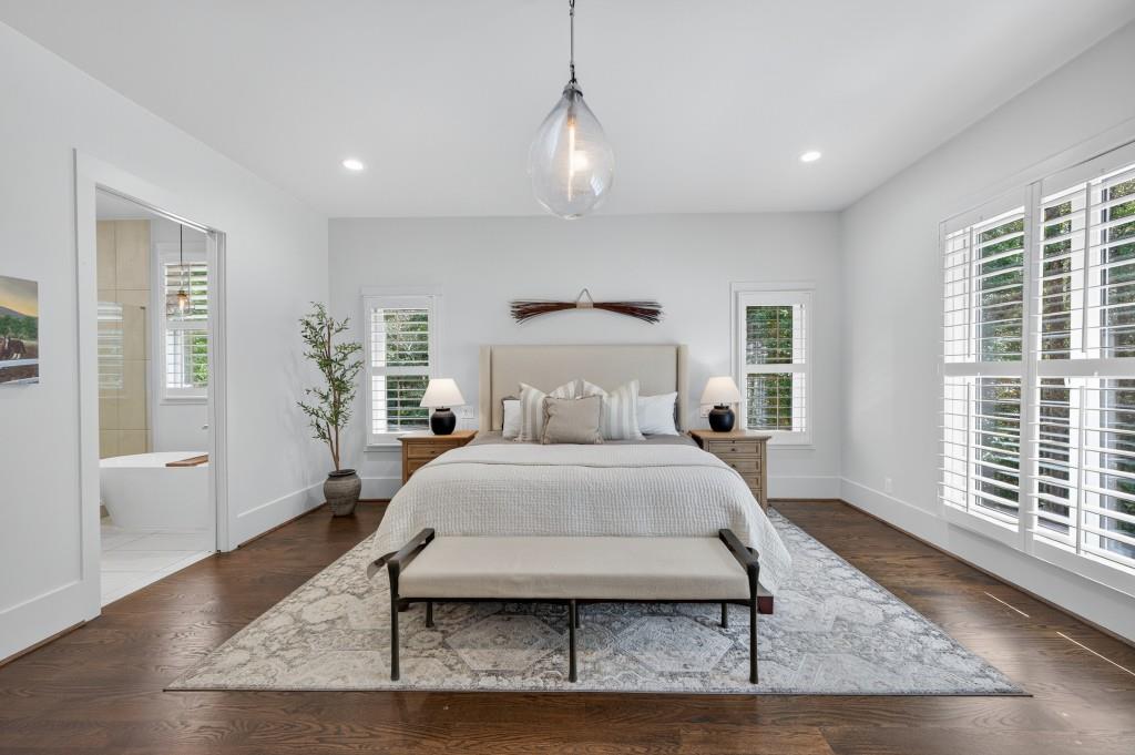 4275 Habersham Way Cumming, GA 30041 - Photo 15 of 34 a spacious bedroom with a bed a window and wooden floor